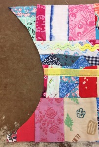 Next I ironed a stabilizer to the back of the pieced section then made a paper egg template. I cut out an egg shape with about a 3/4 inch margin all around.