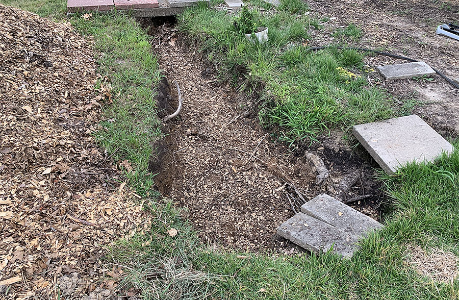 This is the site of the future pond. I've been filling it in with mulch between rains until we get it done. This makes more work for us and makes it take longer to get done, but it's what we have to do. Does every construction site in St. Louis County have to fill in every puddle between rains, even if they dry up in a day or two? This photo was taken on August 25, about 24 hours ago. It's rained three times since then. If it's not dry right now, about an hour after the rain stopped, should we have to go to court again? What do you think?