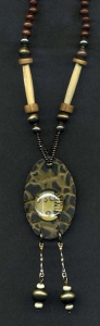 Necklace with gold and black oval pendant with glass.