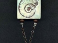 Necklace with mollusk pendant.