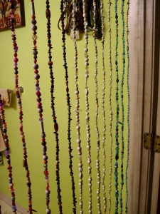 I've always wanted a beaded curtain, so I made one for my bathroom door from recycled florist wire and plastic beads mostly taken from thrift store jewelry. One wall in the bathroom is painted my favorite color, lime green. The other walls will be painted when the tile work on the walls is finished.