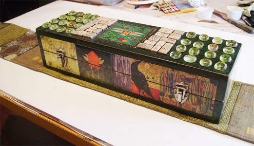 Ammo box decorated with mixed media including decoupage.