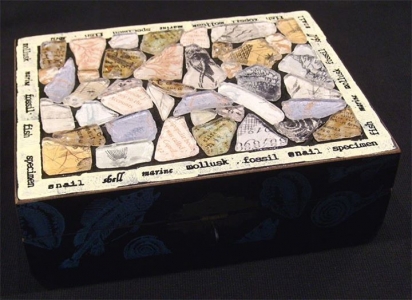 This box was decorated on top with faux beach glass pieces backed with decorative paper. I added some rubber stamping around the sides and the lid border. The source of the box was a thrift store.