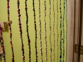 I've always wanted a beaded curtain, so I made one for my bathroom door from recycled florist wire and plastic beads mostly taken from thrift store jewelry. One wall in the bathroom is painted my favorite color, lime green. The other walls will be painted when the tile work on the walls is finished.
